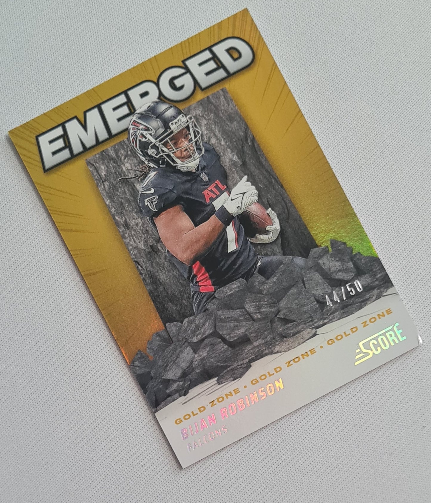 Bijan Robinson - 2024 Panini Score Football NFL Atlanta Falcons Emerged Gold Zone #EM-BRN /50 (damaged corner)