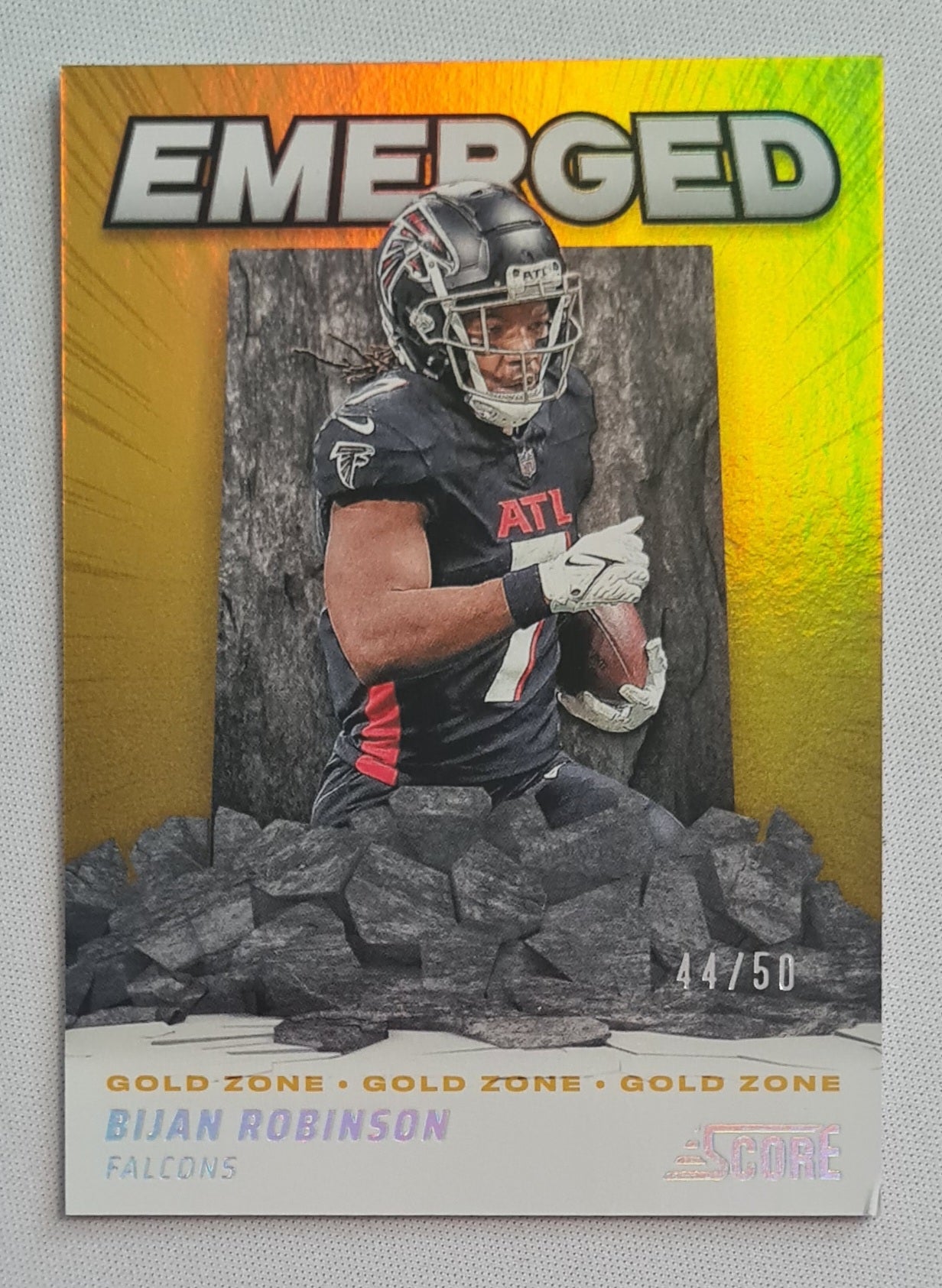 Bijan Robinson - 2024 Panini Score Football NFL Atlanta Falcons Emerged Gold Zone #EM-BRN /50 (damaged corner)