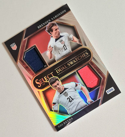 Brenden Aaronson & Gio Reyna - 2022/23 Panini Select FIFA Soccer National Team USA - Dual Swatches #DS-USA Prizm /Dual Patch