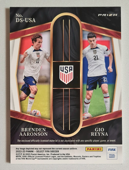 Brenden Aaronson & Gio Reyna - 2022/23 Panini Select FIFA Soccer National Team USA - Dual Swatches #DS-USA Prizm /Dual Patch