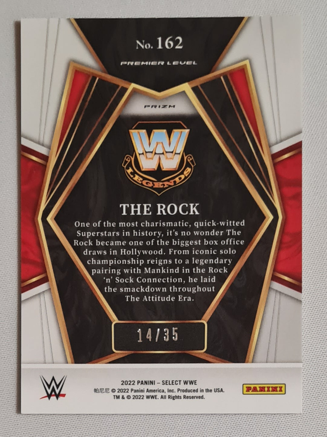 The Rock - 2022 Panini Select WWE Wrestling Legends #162 Premier Level Orange Prizm /35