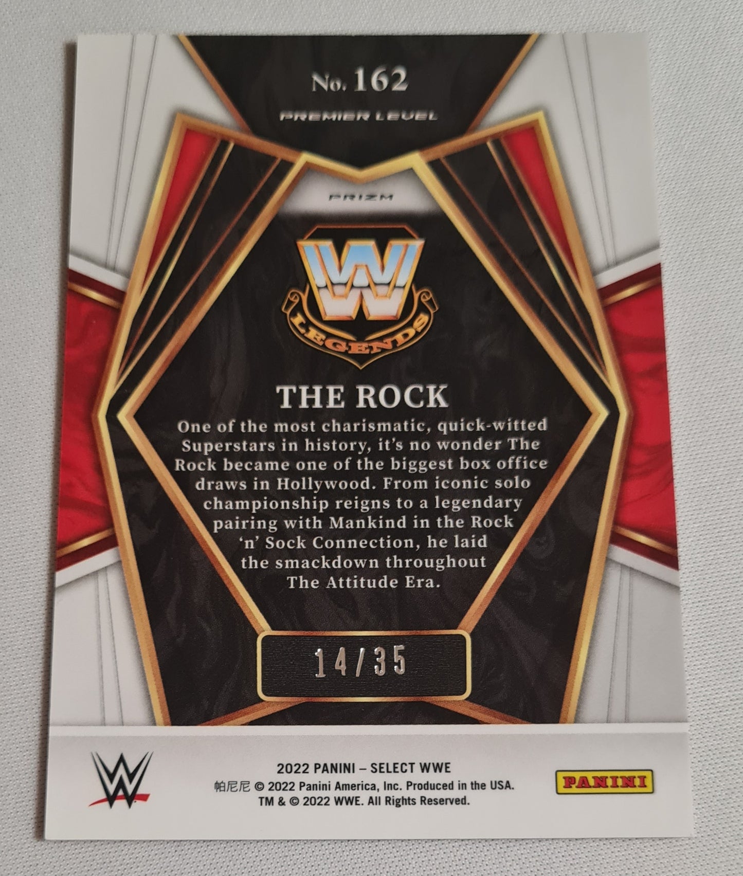 The Rock - 2022 Panini Select WWE Wrestling Legends #162 Premier Level Orange Prizm /35