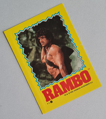 Rambo - 1985 Topps Sticker Card ANABASIS INVESTMENTS N.V. Sylvester Stallone #8